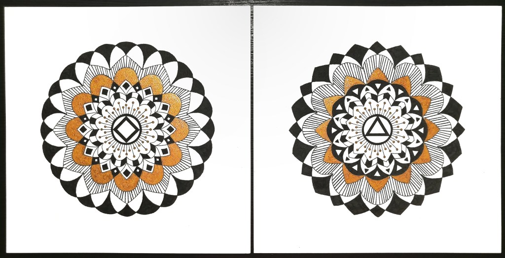 two black white and gold mandalas